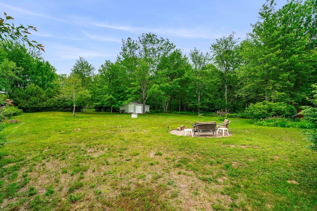 578 Little River Rd, Lebanon, ME 04027 - view of green lawn featuring an outdoor fire pit and a storage shed