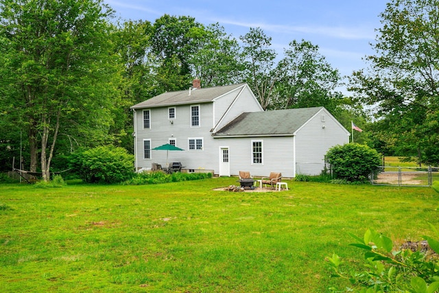 578 Little River Rd, Lebanon, ME 04027 - rear view of house with an outdoor fire pit and a chimney