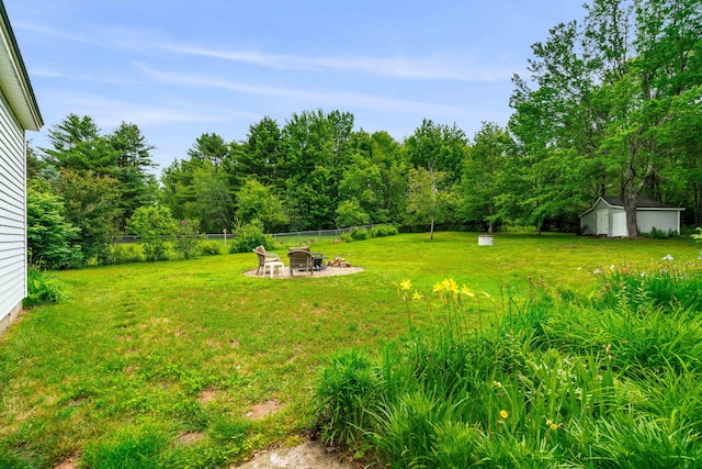 578 Little River Rd, Lebanon, ME 04027 - view of yard featuring an outdoor fire pit, a storage shed, and a patio