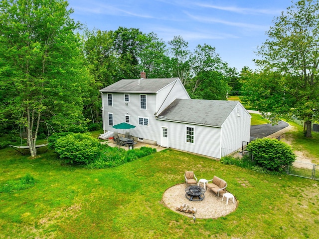 578 Little River Rd, Lebanon, ME 04027 - rear view of property featuring an outdoor fire pit, a chimney, a patio area, and roof with shingles