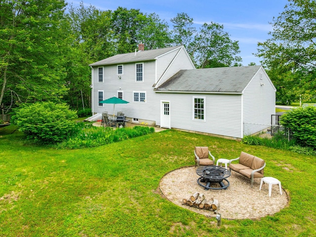 578 Little River Rd, Lebanon, ME 04027 - back of house featuring a fire pit, a yard, a chimney, a patio, and a shingled roof