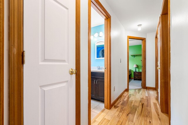 578 Little River Rd, Lebanon, ME 04027 - corridor with light wood-style floors and a sink