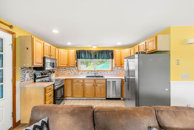 578 Little River Rd, Lebanon, ME 04027 - kitchen with appliances with stainless steel finishes, light countertops, decorative backsplash, open floor plan, and recessed lighting