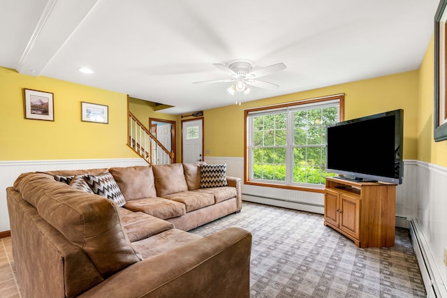 578 Little River Rd, Lebanon, ME 04027 - living room featuring wainscoting, baseboard heating, stairs, light colored carpet, and ceiling fan