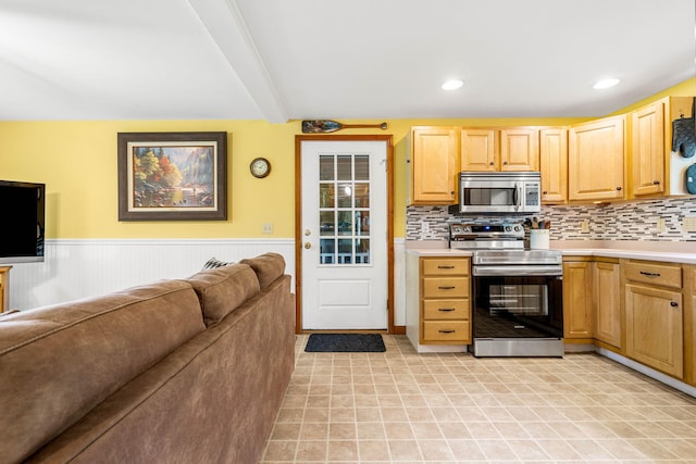 578 Little River Rd, Lebanon, ME 04027 - kitchen with appliances with stainless steel finishes, light brown cabinets, open floor plan, light countertops, and beamed ceiling