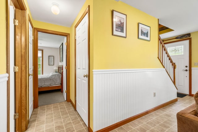 578 Little River Rd, Lebanon, ME 04027 - corridor with stairs and a wainscoted wall
