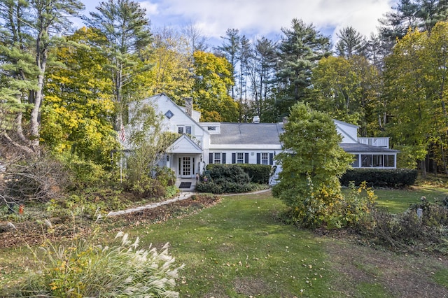 9 Dry Point Dr, Rome, ME 04963 - view of front of house featuring a chimney, a front lawn, and view of wooded area