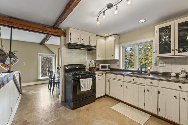 9 Dry Point Dr, Rome, ME 04963 - kitchen featuring black range with gas stovetop, white microwave, under cabinet range hood, a sink, and dark countertops