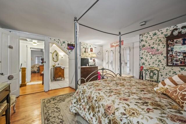 9 Dry Point Dr, Rome, ME 04963 - bedroom featuring wood finished floors, wallpapered walls, and ensuite bath