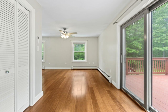 20 Cobble Hill Rd, New Gloucester, ME 04260 - unfurnished living room with a baseboard radiator, wood finished floors, a ceiling fan, baseboards, and a baseboard heating unit