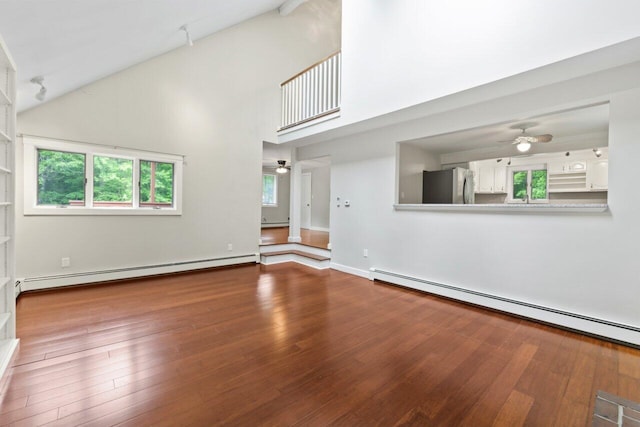 20 Cobble Hill Rd, New Gloucester, ME 04260 - unfurnished living room featuring a ceiling fan, a baseboard heating unit, high vaulted ceiling, and hardwood / wood-style floors
