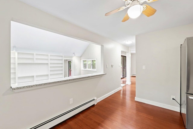 20 Cobble Hill Rd, New Gloucester, ME 04260 - unfurnished room with baseboard heating, wood finished floors, baseboards, ceiling fan, and vaulted ceiling