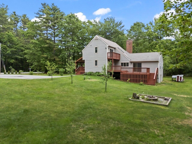 20 Cobble Hill Rd, New Gloucester, ME 04260 - back of house with an outdoor fire pit, a lawn, a chimney, a wooden deck, and a balcony