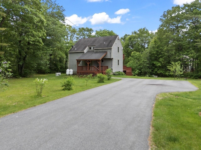 20 Cobble Hill Rd, New Gloucester, ME 04260 - view of front of home featuring a wooden deck, a front yard, roof with shingles, and driveway