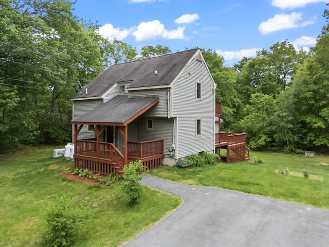 20 Cobble Hill Rd, New Gloucester, ME 04260 - view of front facade featuring a shingled roof, a wooden deck, and a front yard