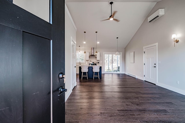 19 Efficiency Way, Bridgton, ME 04009 - entryway with a wall unit AC, ceiling fan, high vaulted ceiling, dark wood-style floors, and baseboards