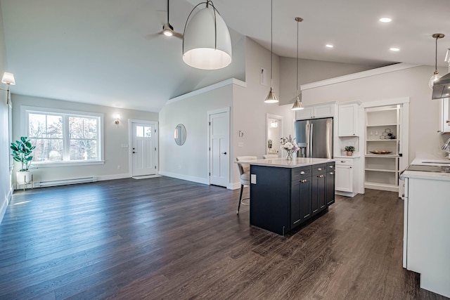 19 Efficiency Way, Bridgton, ME 04009 - kitchen featuring stainless steel fridge with ice dispenser, white cabinetry, light countertops, high vaulted ceiling, and a kitchen breakfast bar