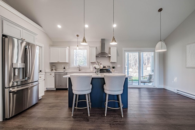 19 Efficiency Way, Bridgton, ME 04009 - kitchen with appliances with stainless steel finishes, vaulted ceiling, wall chimney range hood, light countertops, and dark wood-style flooring