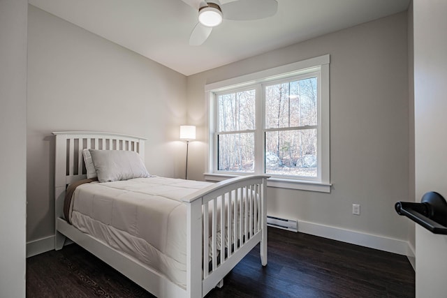 19 Efficiency Way, Bridgton, ME 04009 - bedroom featuring a baseboard radiator, dark wood-type flooring, baseboards, and a ceiling fan