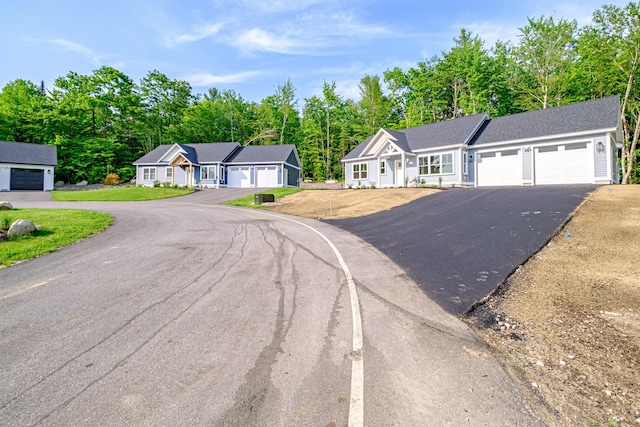 19 Efficiency Way, Bridgton, ME 04009 - ranch-style home with an attached garage, driveway, and view of scattered trees