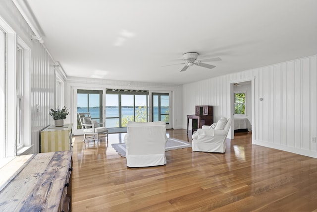 43 Gingers Rd, Harpswell, ME 04079 - living room featuring light wood-style floors, a water view, and a ceiling fan