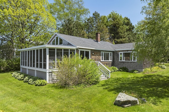 43 Gingers Rd, Harpswell, ME 04079 - view of front of house featuring a sunroom, a front yard, a chimney, and a shingled roof
