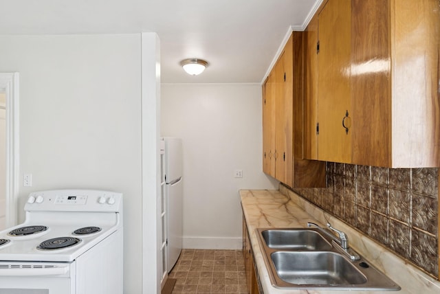 20 Green St, Winthrop, ME 04364 - kitchen with white appliances, a sink, baseboards, tasteful backsplash, and light countertops