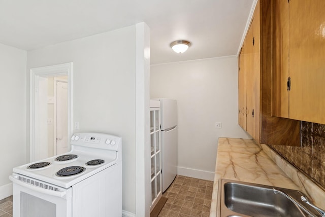 20 Green St, Winthrop, ME 04364 - kitchen featuring white appliances, a sink, baseboards, and light countertops