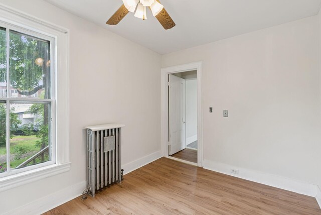 20 Green St, Winthrop, ME 04364 - unfurnished room with radiator, healthy amount of natural light, light wood-style floors, and a ceiling fan