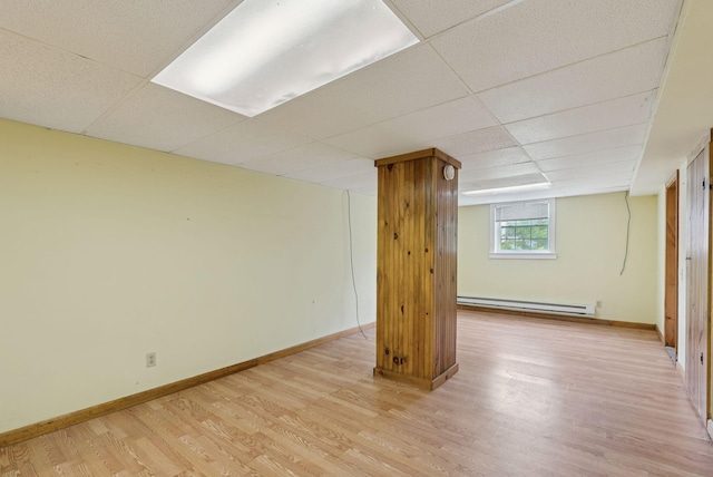 20 Green St, Winthrop, ME 04364 - below grade area featuring baseboard heating, light wood finished floors, a drop ceiling, and baseboards