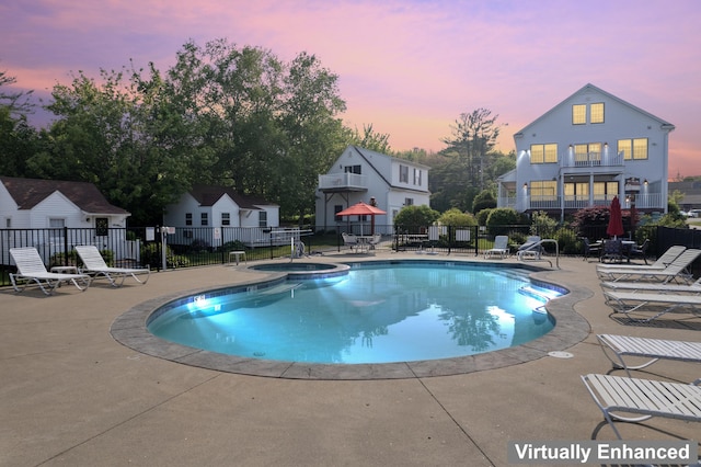 1139 Post Rd Unit 102, Wells, ME 04090 - pool at dusk featuring a patio and a pool with connected hot tub