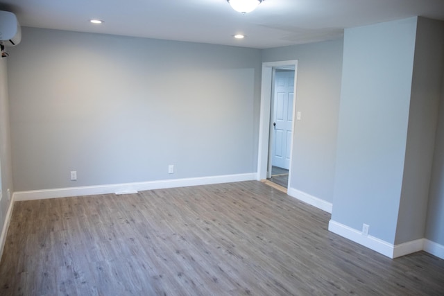2 Watson Ave, Houlton, ME 04730 - spare room with wood finished floors, baseboards, a wall mounted AC, and recessed lighting