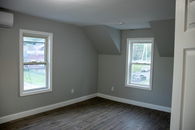 2 Watson Ave, Houlton, ME 04730 - bonus room with a wall unit AC, dark wood finished floors, baseboards, and vaulted ceiling