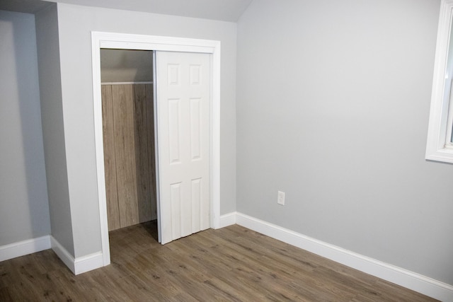 2 Watson Ave, Houlton, ME 04730 - unfurnished bedroom featuring dark wood-type flooring, a closet, and baseboards