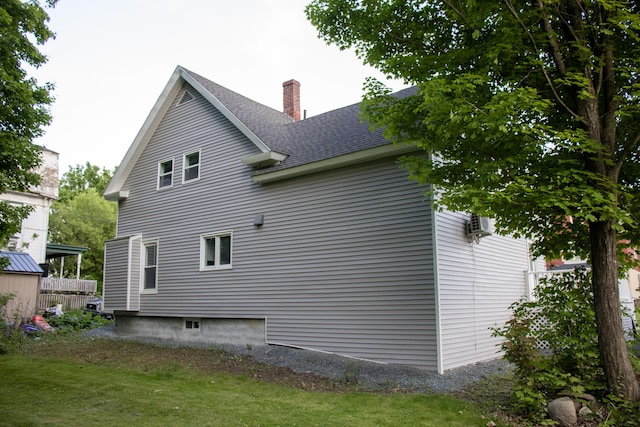 2 Watson Ave, Houlton, ME 04730 - view of home's exterior featuring a chimney, roof with shingles, and a yard