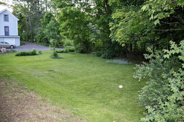2 Watson Ave, Houlton, ME 04730 - view of green lawn with asphalt driveway