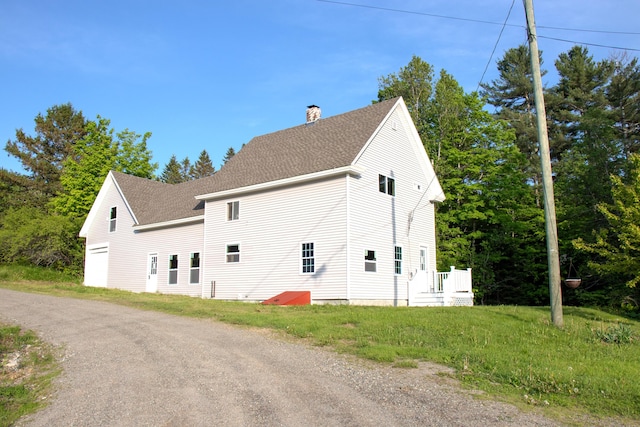 16 Gerry Rd, Sherman, ME 04776 - view of side of home featuring roof with shingles and a chimney