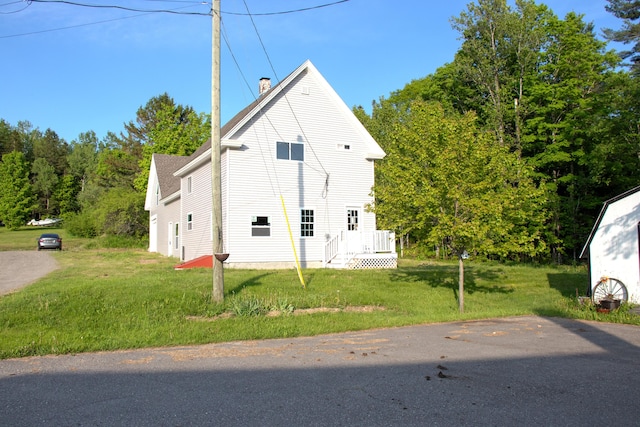 16 Gerry Rd, Sherman, ME 04776 - view of property exterior with a chimney and a yard