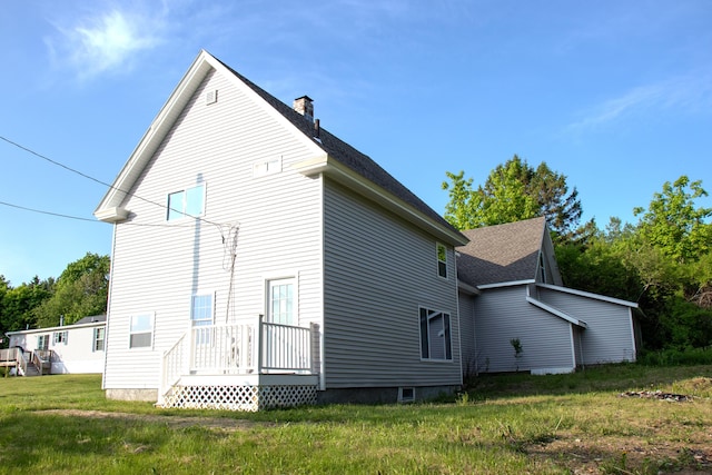 16 Gerry Rd, Sherman, ME 04776 - rear view of house with a chimney, a shingled roof, and a yard