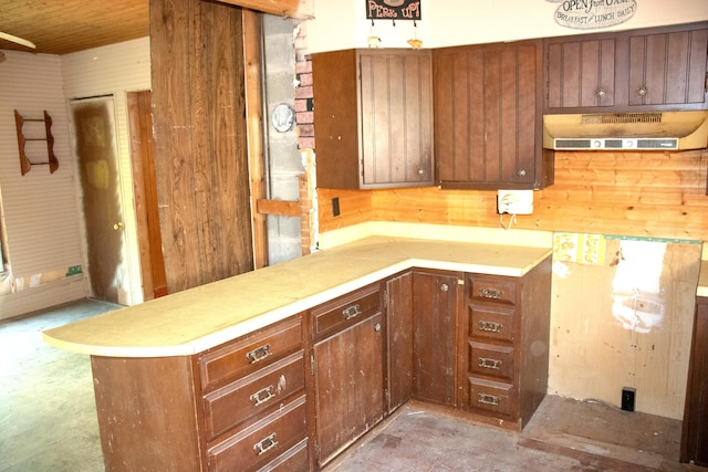 16 Gerry Rd, Sherman, ME 04776 - kitchen featuring unfinished concrete floors, under cabinet range hood, light countertops, a peninsula, and wooden ceiling