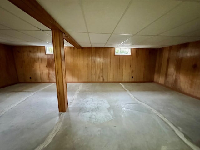 02 Rogers St, Houlton, ME 04730 - basement featuring a drop ceiling, wood walls, and baseboards
