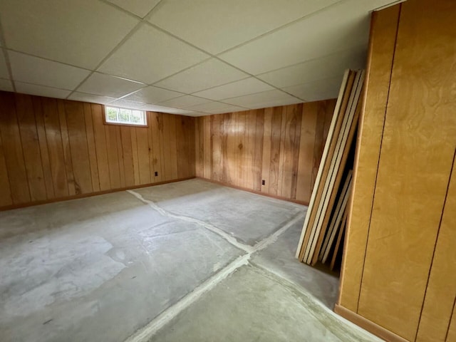 02 Rogers St, Houlton, ME 04730 - below grade area featuring a drop ceiling, baseboards, and wood walls