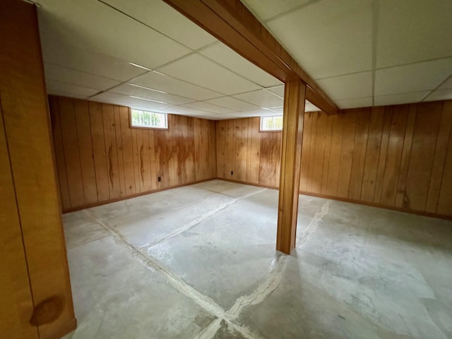 02 Rogers St, Houlton, ME 04730 - basement featuring a paneled ceiling, wood walls, and baseboards