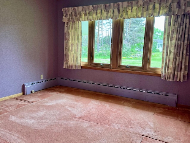 02 Rogers St, Houlton, ME 04730 - carpeted spare room with healthy amount of natural light, baseboard heating, and a textured wall
