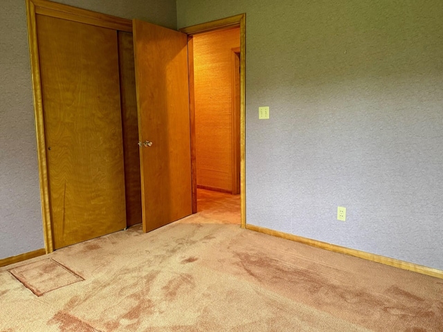 02 Rogers St, Houlton, ME 04730 - unfurnished bedroom with carpet floors, a closet, a textured wall, and baseboards