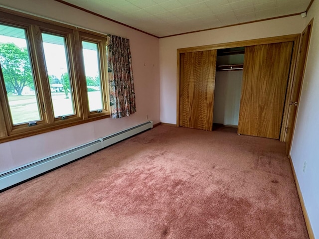 02 Rogers St, Houlton, ME 04730 - unfurnished bedroom with a baseboard radiator, light carpet, ornamental molding, and a closet