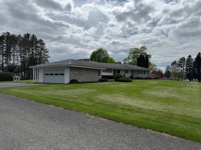02 Rogers St, Houlton, ME 04730 - ranch-style house with asphalt driveway, a garage, and a front lawn