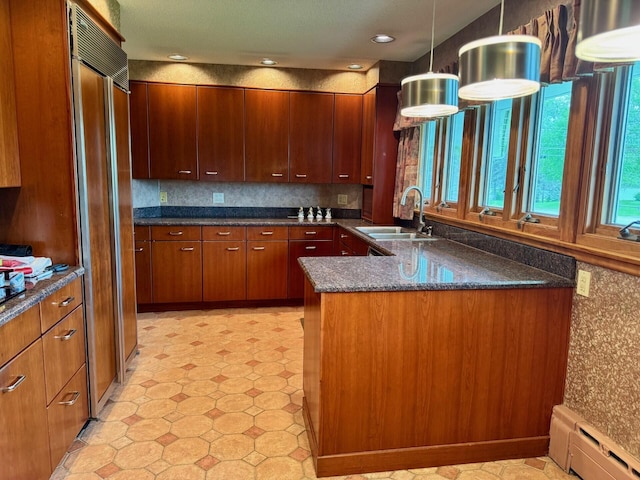 02 Rogers St, Houlton, ME 04730 - kitchen with a sink, baseboard heating, light floors, a peninsula, and decorative light fixtures
