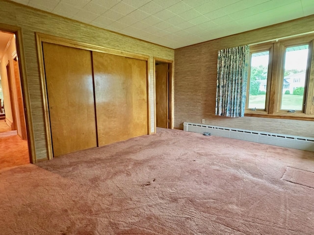 02 Rogers St, Houlton, ME 04730 - unfurnished bedroom featuring carpet, baseboard heating, and a closet