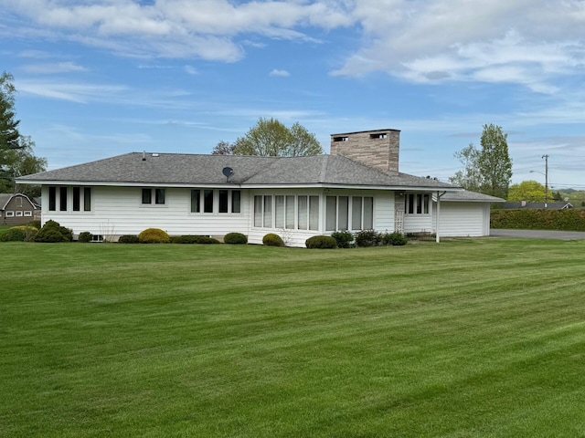 02 Rogers St, Houlton, ME 04730 - back of house featuring a lawn, driveway, a chimney, and a garage